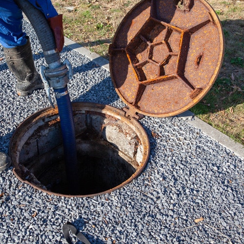The clearing service is checking the sewer to make sure it is not clogged